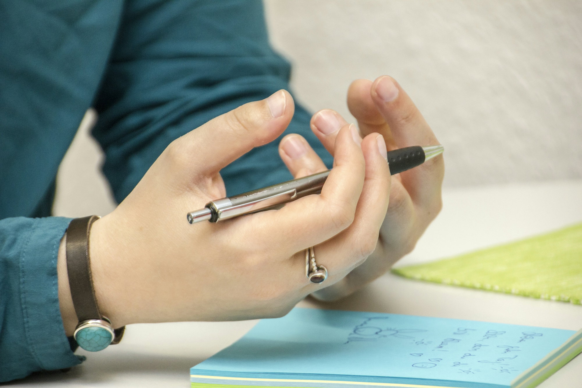 a-person-sitting-at-a-table-using-a-cell-phone.jpg a person sitting at a table using a cell phone
